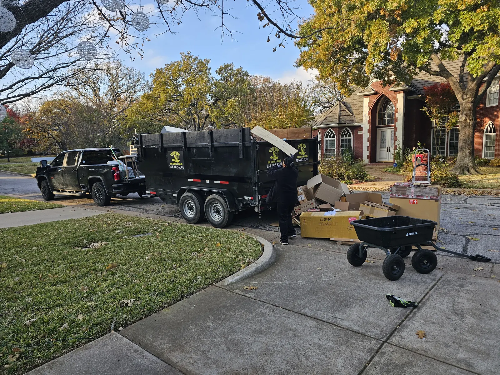 Yellow Rose crew loading junk into trailer at a DFW home