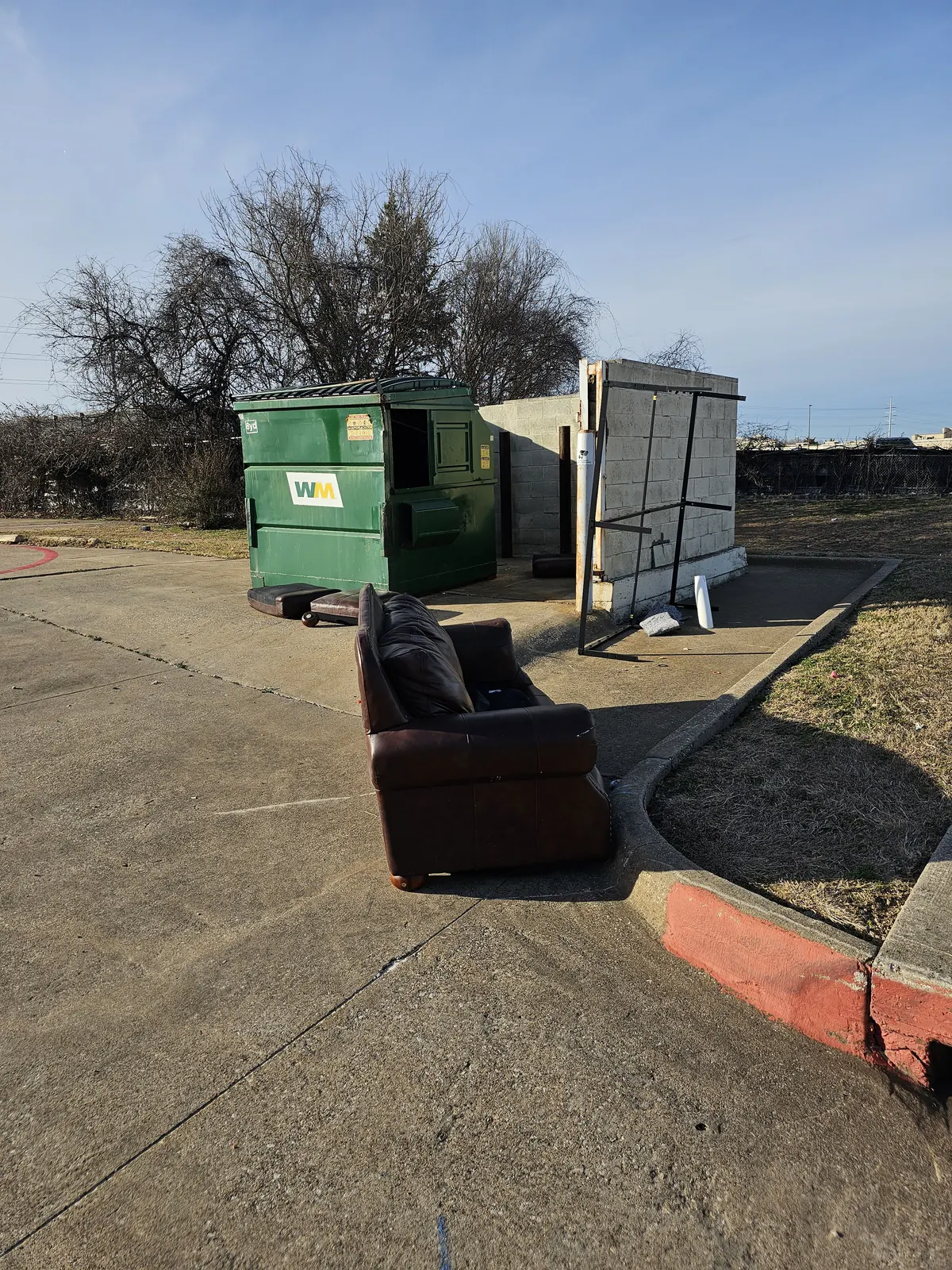 Old sofa picked up next to apartment dumpster