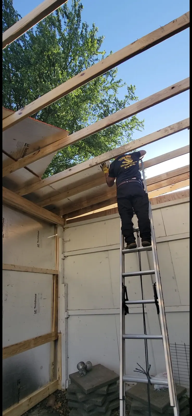 Crew taking down wood frame structure