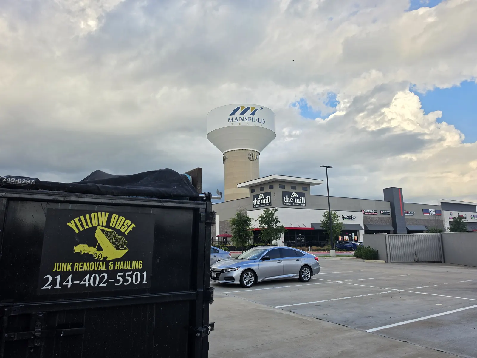 Yellow Rose junk removal trailer in Mansfield TX by the water tower